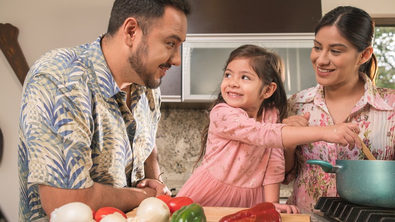 Family happily cooking together