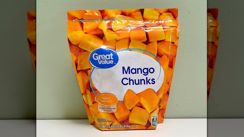 A bag of Great Value Mango Chunks on a green and white background