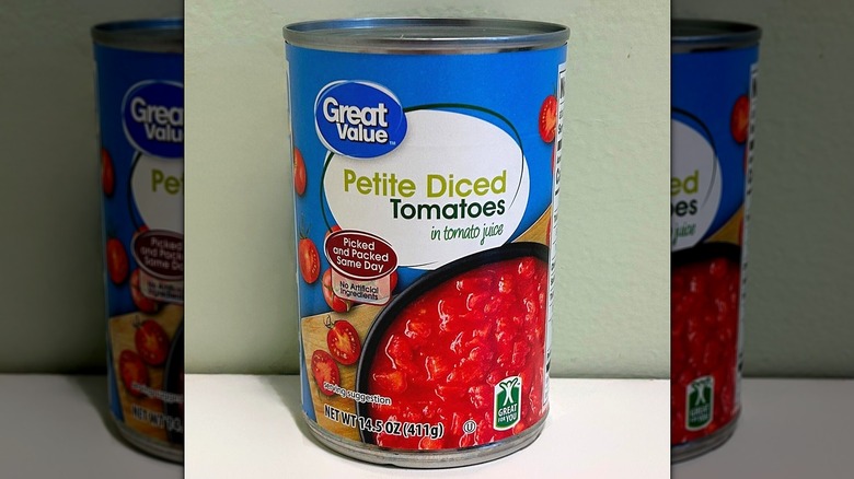 A can of Great Value Petite Diced Tomatoes on a green and white background