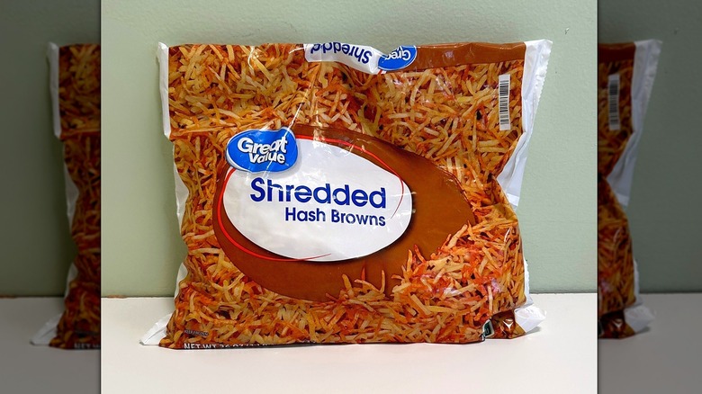 A bag of Great Value Shredded Hash Browns on a green and white background