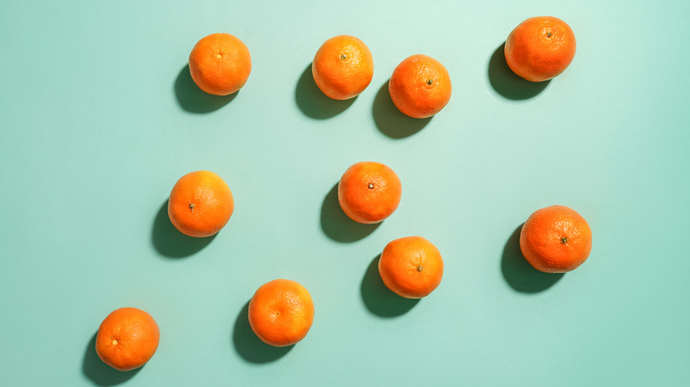 Clementines on a green background