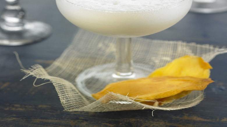 Close-up on a frothy golden Cadillac cocktail in glass