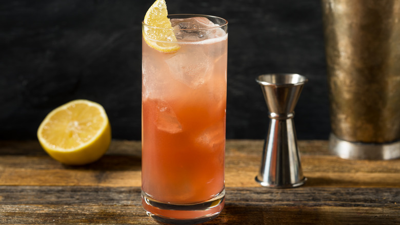 Sloe gin fizz cocktail set on table