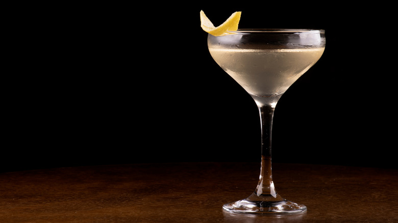 Vesper martini with lemon peel against black backdrop
