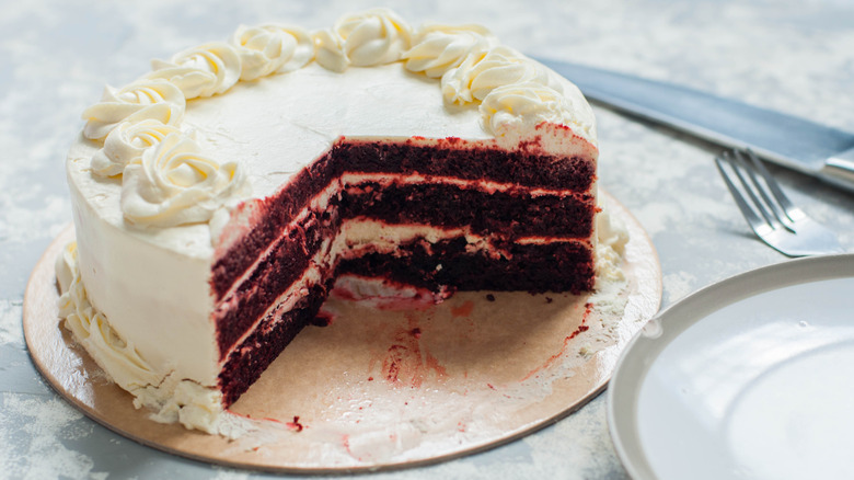 A red velvet cake cut to show the layers inside