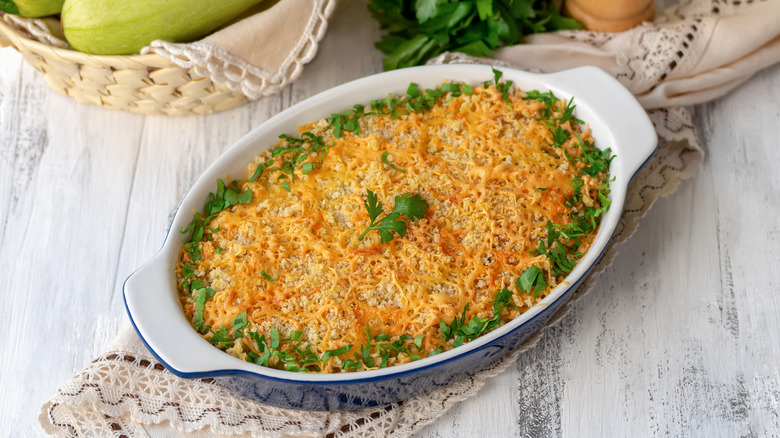 Squash casserole in oval dish garnished with parsley