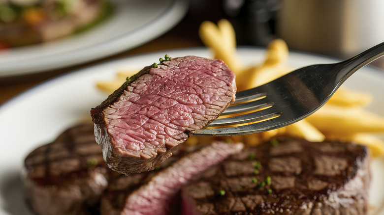 A piece of steak on a fork