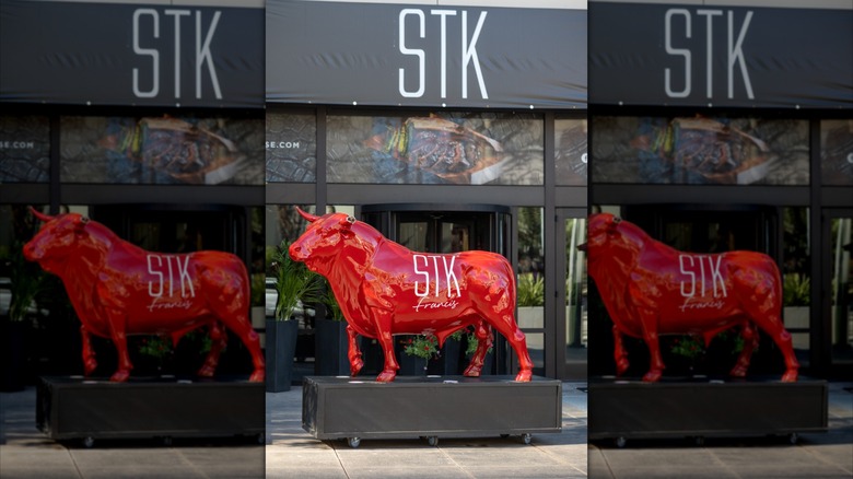 STK Steakhouse exterior, with the model of a red bull, STK Francis, outside