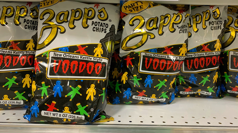 A row of Zapp's Voodoo chips on a store shelf.