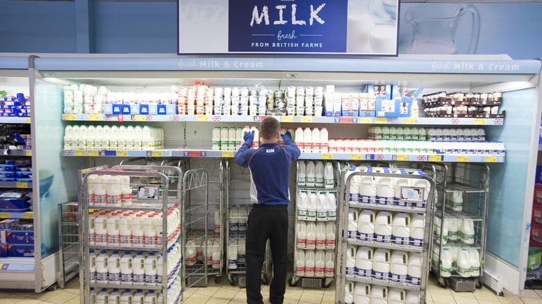 staff member stocking Aldi shelves