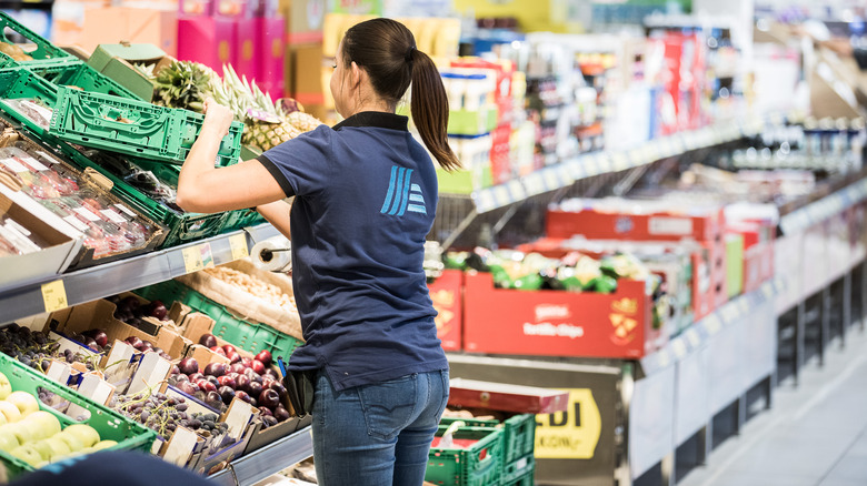 Aldi worker stocking shelves