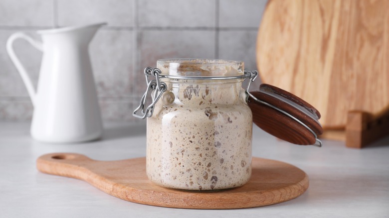 Sourdough starter in a glass jar on a kitchen counter