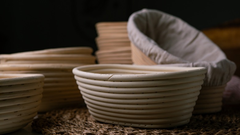 Bread proofing baskets against a black background