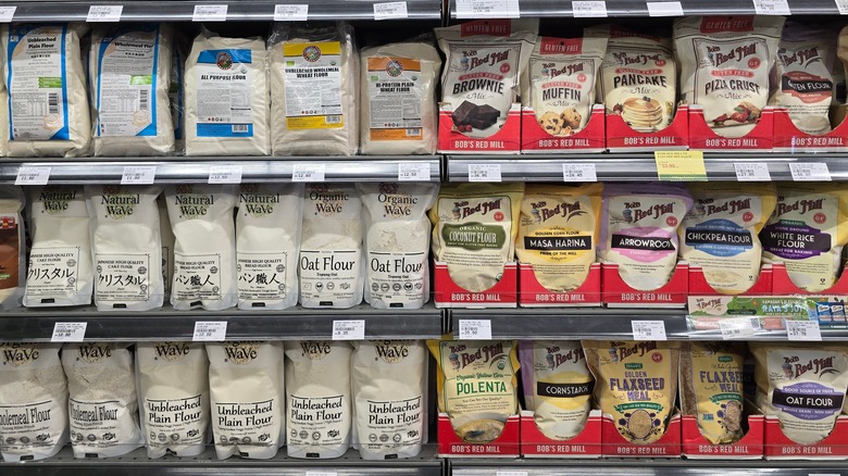 Various flour types on shelves in a supermarket