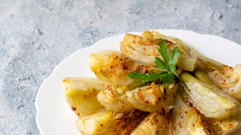 baked fennel bulbs on white plate