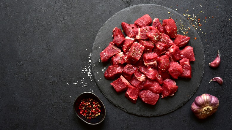 Preparing steak for skewers
