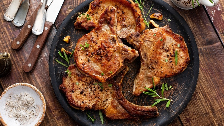 Four pork chops on plate