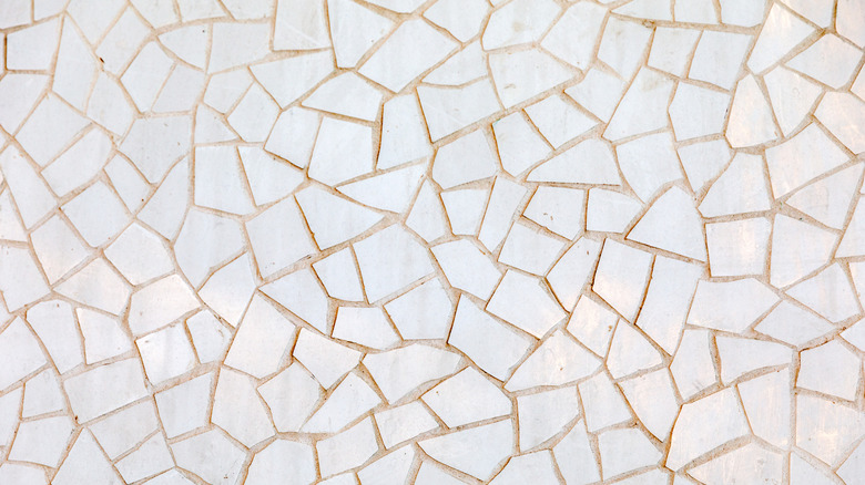 A close-up of a mosaic of broken white marble tile