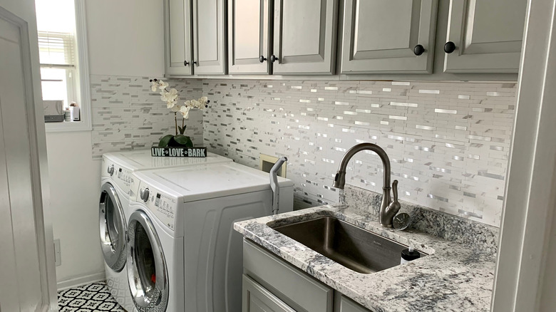 Contemporary laundry room with stick-on tile backsplash