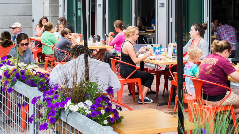 People eating on the outdoor patio at Bread Garden Market