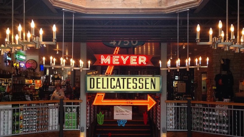 Interior of Gene's Sausage Shop with signs and decorative lighting