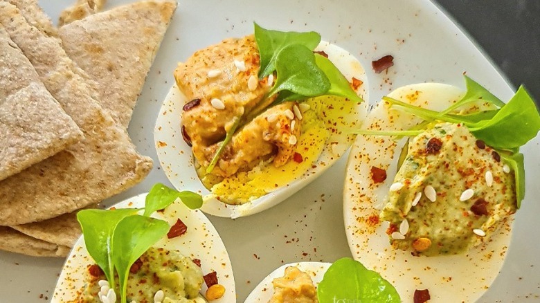 Deviled eggs with sun-dried tomato and pesto