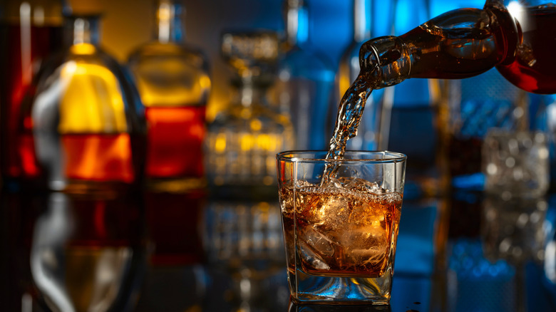 Whiskey being poured from bottle to glass