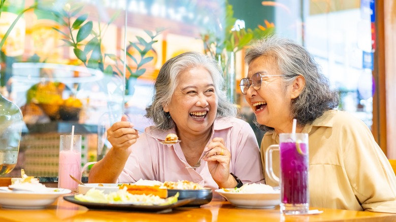 A pair of senior ladies enjoying a discounted meal at a chain restaurant