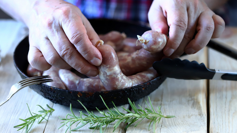 Adding sausages to cold pan
