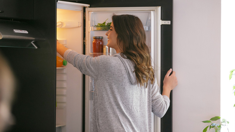 A woman opening the fridge