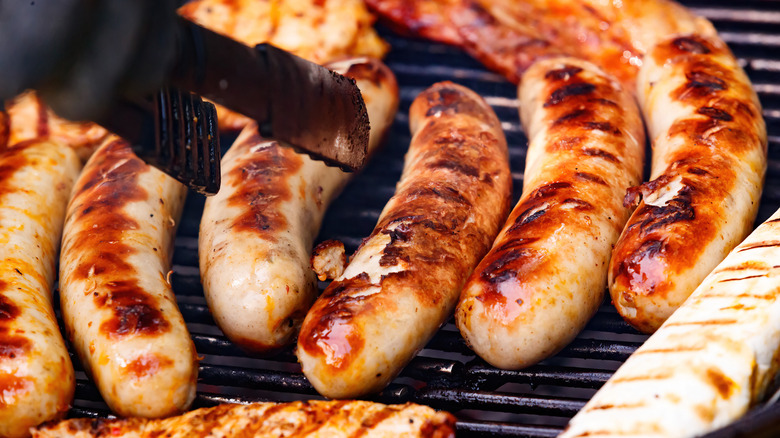 Turning sausages with tongs