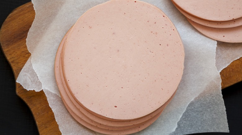 Sliced bologna on cutting board