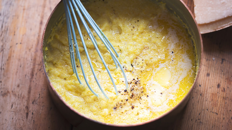 Grits stirred in a copper pot