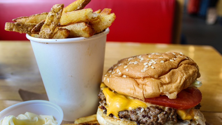Five Guys fries in cup, with burger next to it