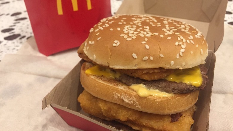 Sandwich with burger, fish, and chicken