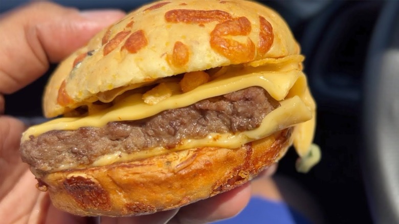 hand holding loaded nacho burger