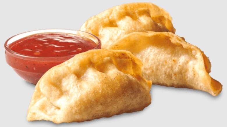 Three Sheetz Pork Pork Stickerz dumplings with a small bowl of dipping sauce