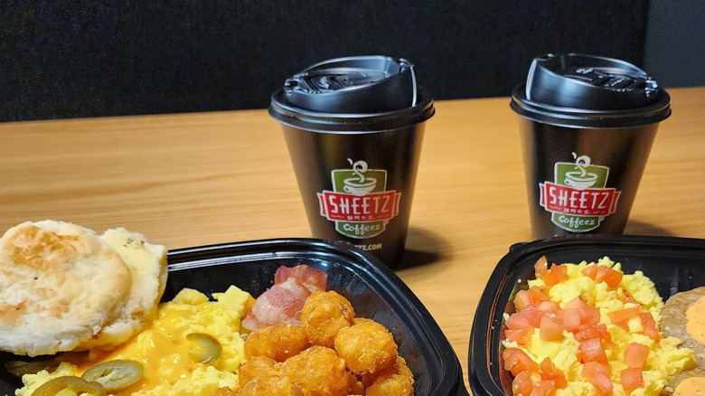 Two Sheetz coffee cups and takeout breakfast platters