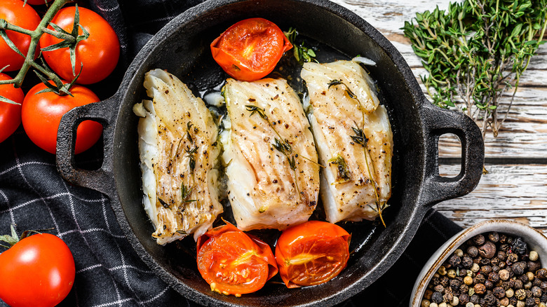 Fish in cast iron with tomatoes