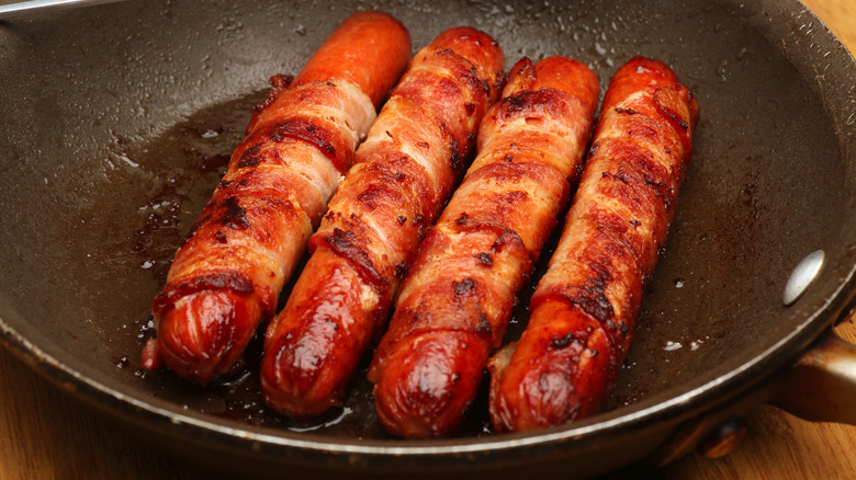 bacon-wrapped hot dogs in pan