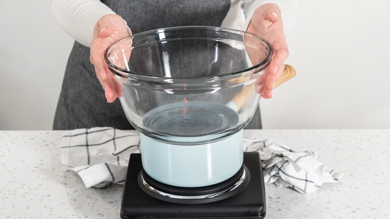 Person assembling double boiler