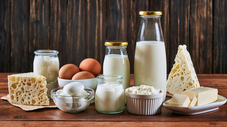 Various dairy products and eggs on a wooden table