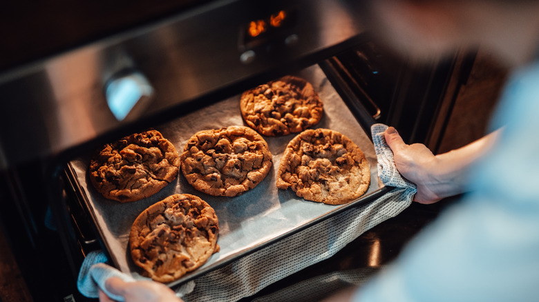 A sheet of cookies coming out of the oven