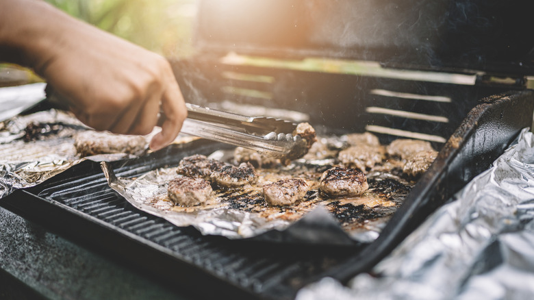 Grilling steak on aluminum foil on the grill