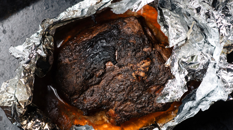 A piece of piece cooked and wrapped in aluminum foil