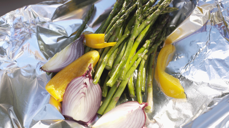 Asparagus, peppers, and onions in aluminum foil