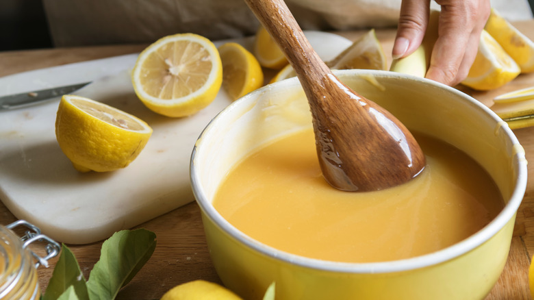 Person stirring lemon curd