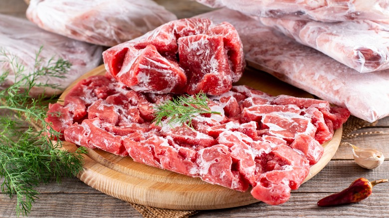 frozen meat on wooden board