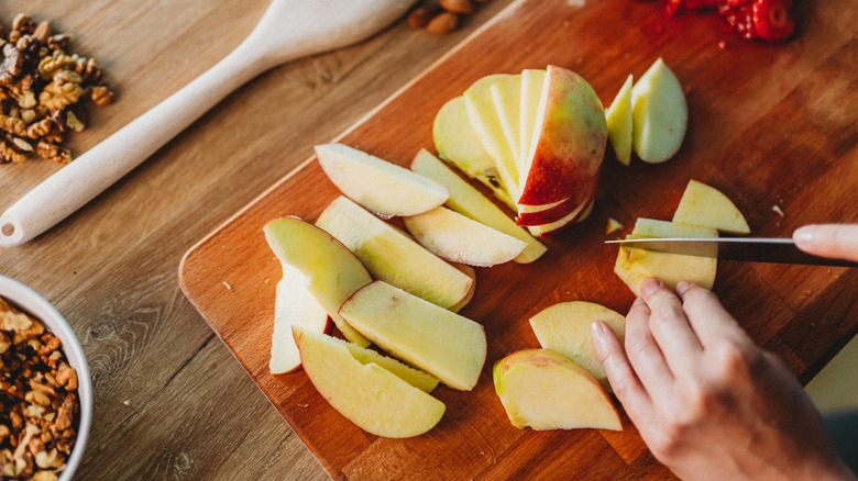 Cutting apples on board