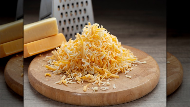 piled of shredded cheese by grater